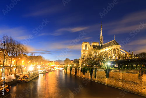 Beautiful view of the river Seine with the Notre-Dame Cathedral in Paris at night photo