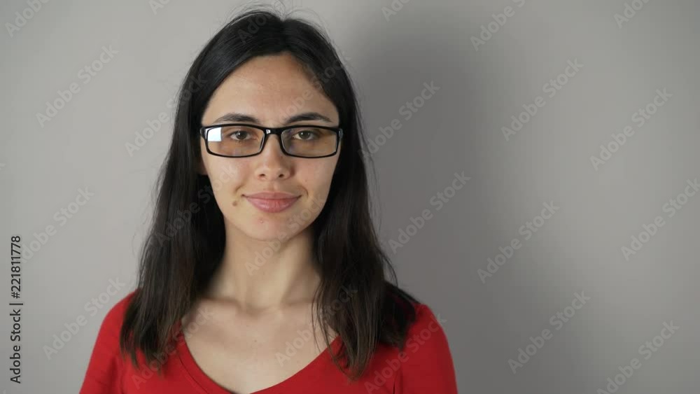 girl with glasses isolated on grey wall background. girl with glasses isolated on grey wall background.