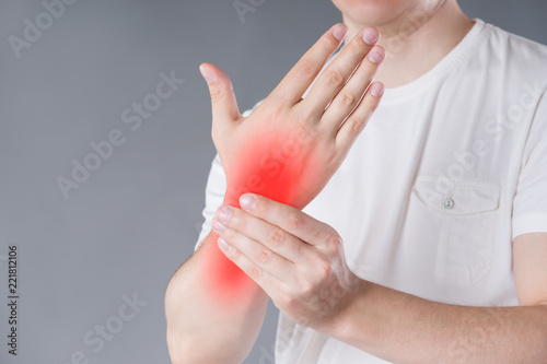 Quadro su tela Pain in hand, carpal tunnel syndrome on gray background