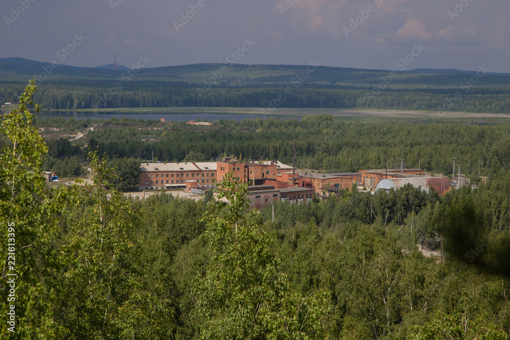 old mining buildings in green forest