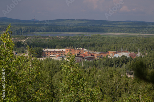 old mining buildings in green forest