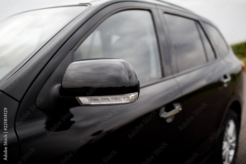 Details of black car. Door car - detail, car mirror close-up. 
