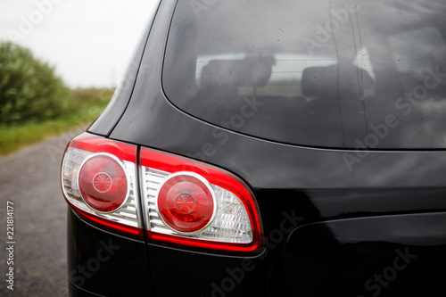 Black premium city crossover, luxury SUV rear light closeup.