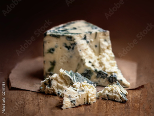 Blue cheese Gorgonzola on a rustic wooden background. Mold cheese with copyspace photo