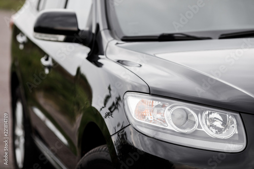 Black modern car closeup. Black modern car headlights - front vi