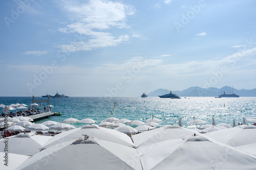 Yatchs and Umbrellas on a beach in Cannes, South of France