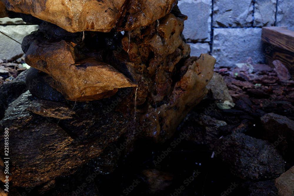 Fountain made of natural stone in the interior Fountain made of natural stone in the interior