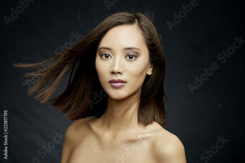 asian girl beauty portrait with make up and wind on dark background