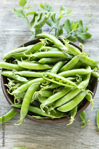 young peas on a wooden background