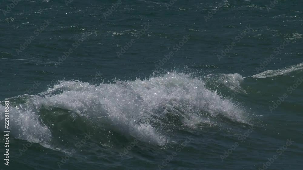 waves with white foam moves thru the sea field Slow motion waves with white foam moves thru the sea field Slow motion