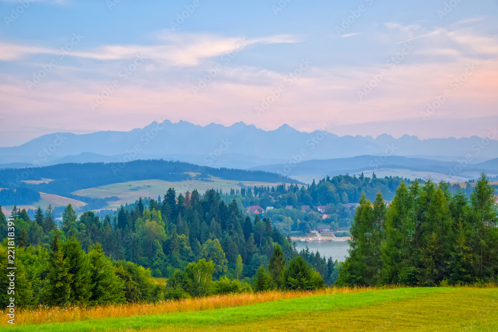 Rural landscape near artificial Czorsztynskie Lake in Southern Poland. High Tatra Mountains in background