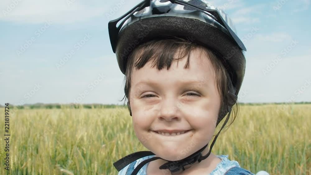 A dirty child in a helmet. Portrait of a dirty happy little girl. A dirty child in a helmet. Portrait of a dirty happy little girl.