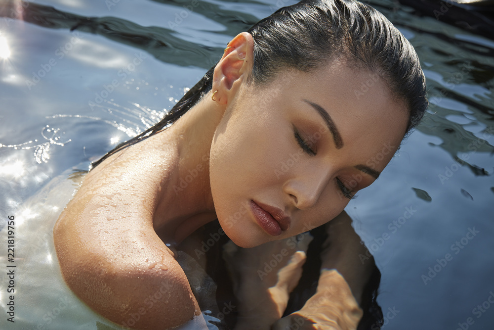 young beautiful asian woman bathing at seaside