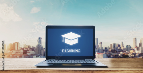 E-learning on computer laptop and city sunrise background. Online education, e-learning and e-book concept