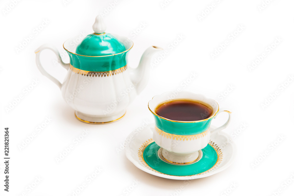 Green indian cup of tea and kettle on white background. Isolated on white