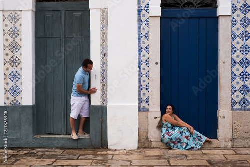 Happy couple in front of the blue doors in a historical city.