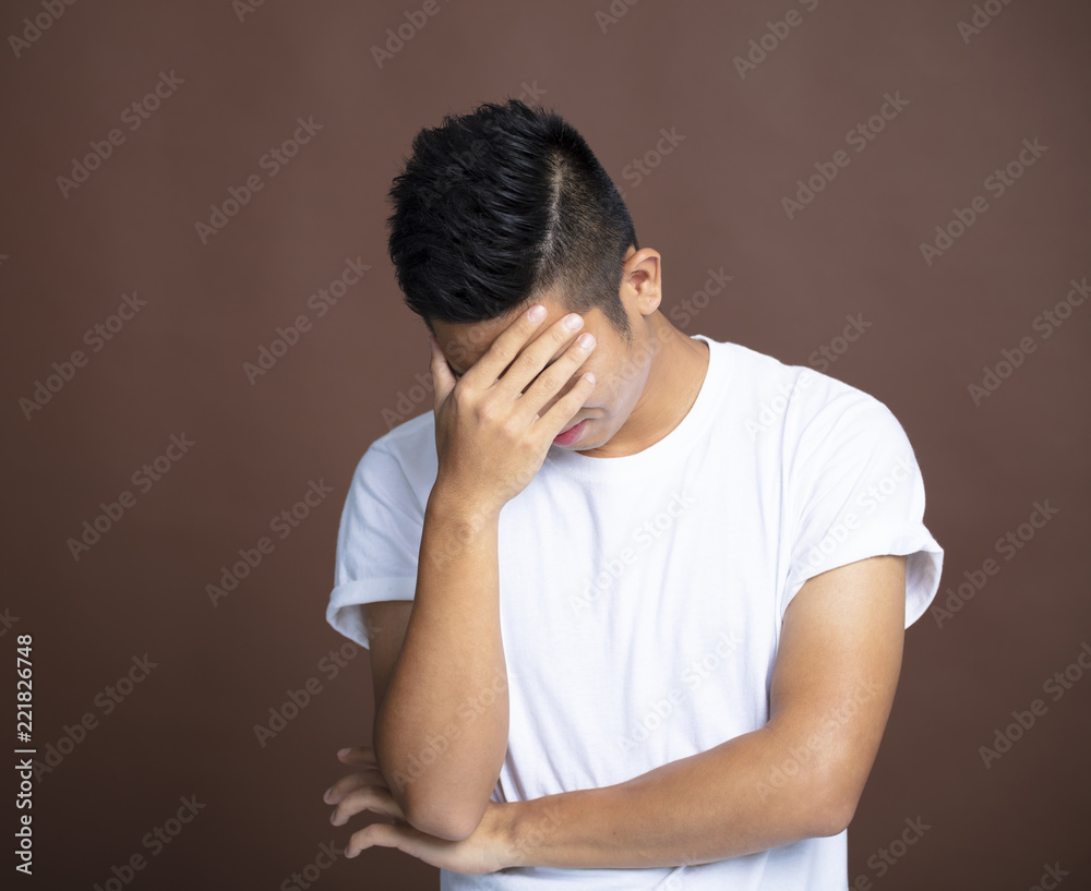stressed young man Cover face by hand