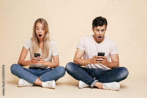 Portrait of a shocked young couple sitting together