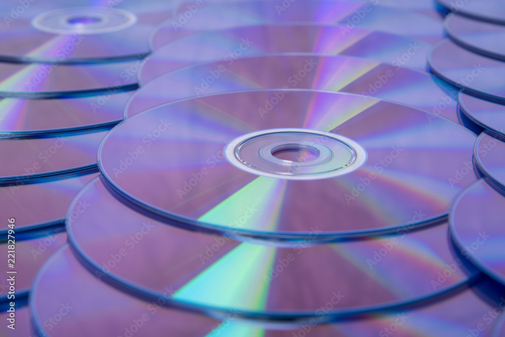 Many musical compact discs with a rainbow spectrum of colors as a bright background Many musical compact discs with a rainbow spectrum of colors as a bright background