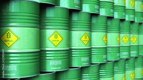 Group of rows of green stacked biofuel drums in storage warehouse
