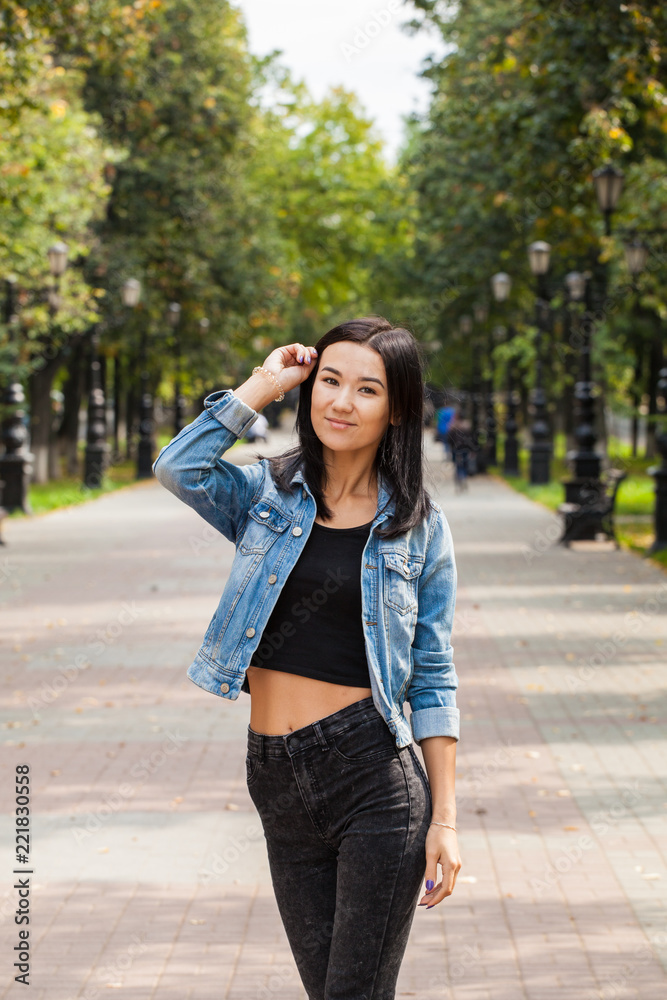 Asian girl in jeans clothes for a walk in the city Asian girl in jeans clothes for a walk in the city