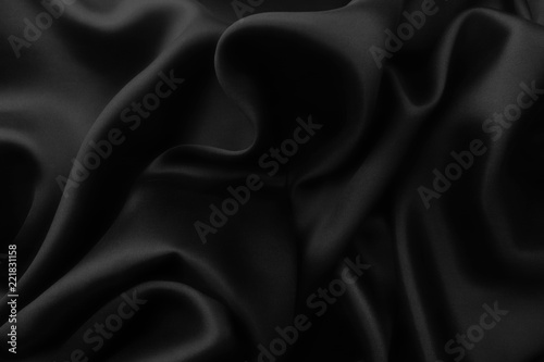 Elegant black satin silk with waves, abstract background.