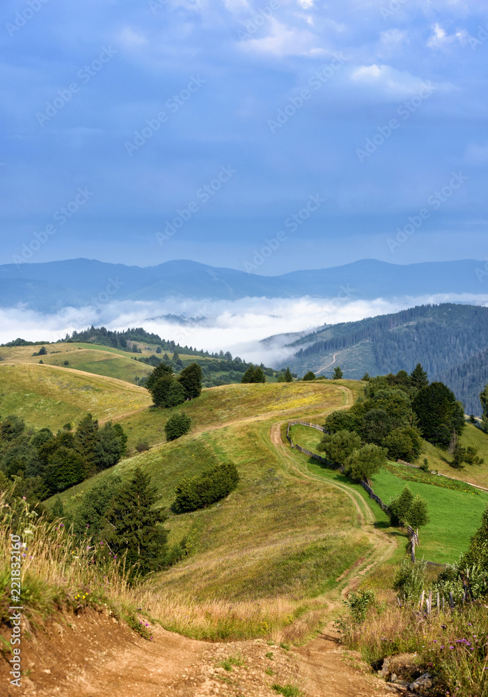 Beautiful rural mountain landscape with road and fog in the valley.  Carpathian, Ukraine, Europe.
