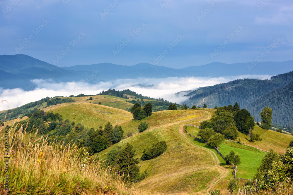 Beautiful rural mountain landscape with fog in the valley.  Carpathian, Ukraine, Europe.