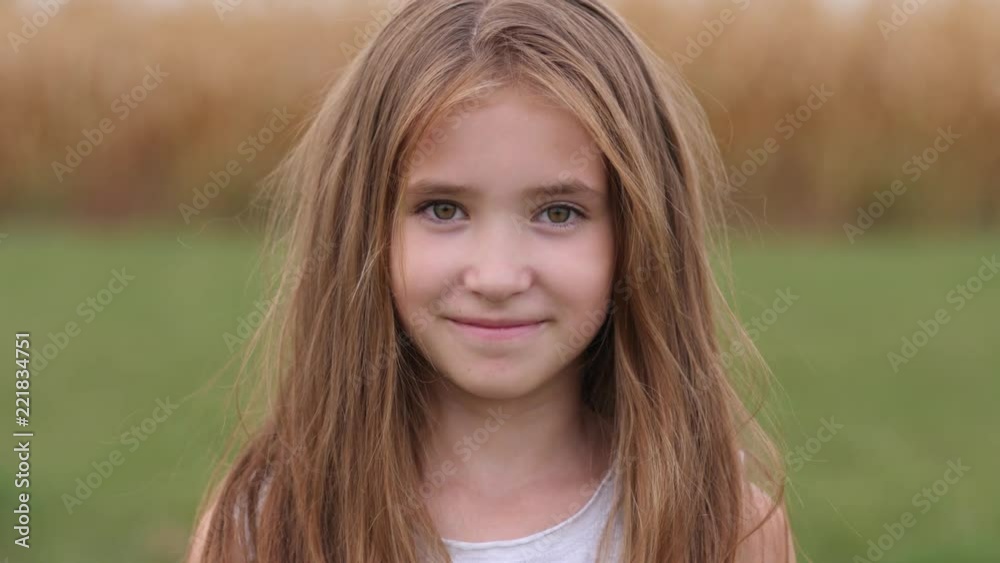 Cute smile child girl portrait posing on nature - happy childhood Cute smile child girl portrait posing on nature - happy childhood