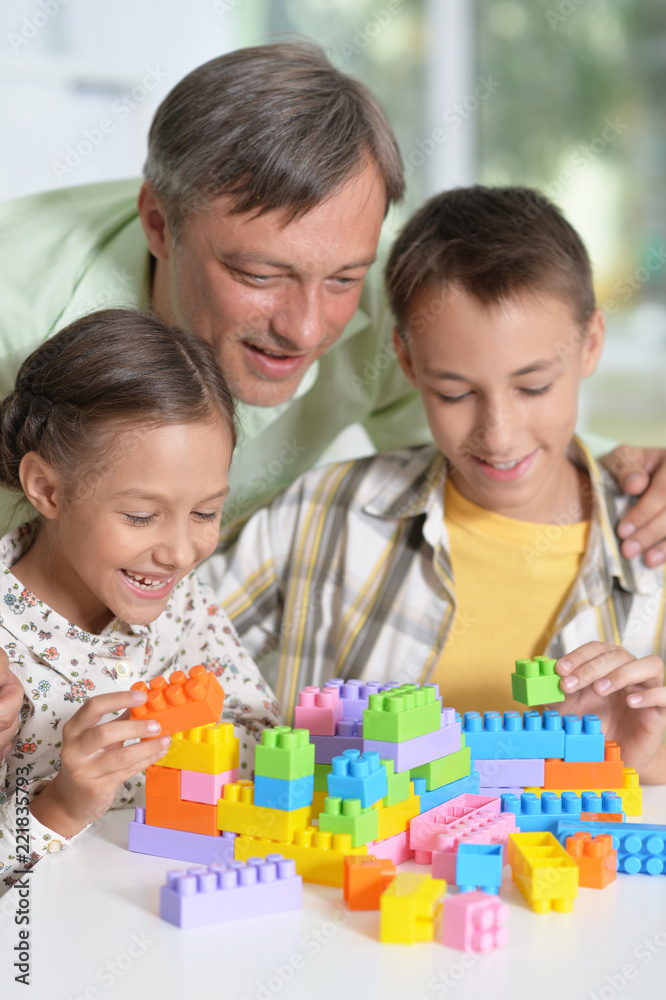 Portrait of father and children playing at home Portrait of father and children playing at home