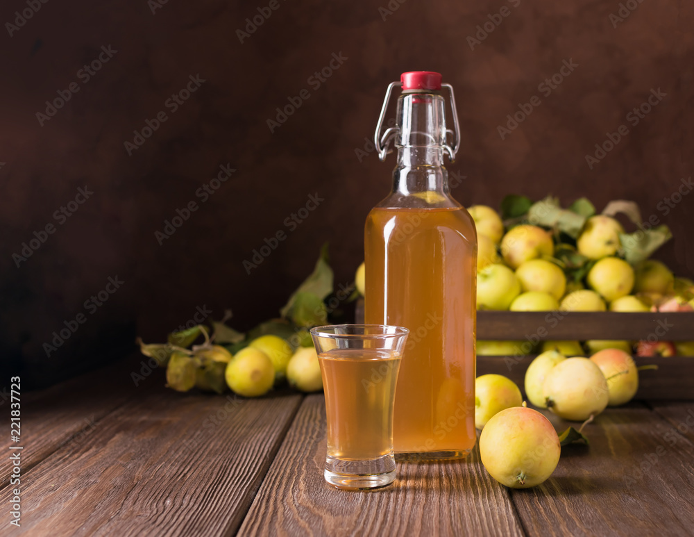 Cocktail of ripe fresh apples in a glass on a wooden background. Apple cider, wine. Cocktail of ripe fresh apples in a glass on a wooden background. Apple cider, wine.