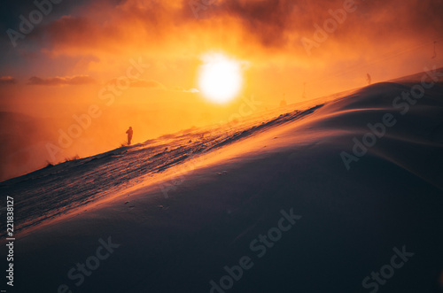 Beautiful sunset in the mountains of the Italian alps. Skier in background