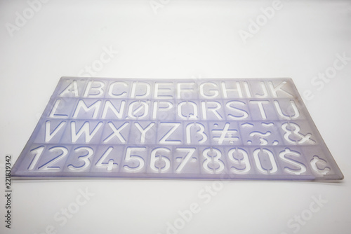 Light blue alphabet stencil lettering PVC plastic ruler template isolated on white