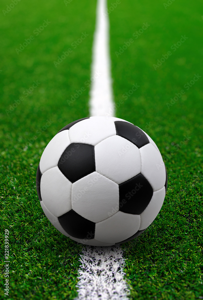 Soccer ball on green football field - obrazy, fototapety, plakaty 