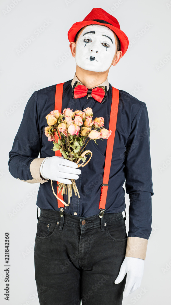 MIM artist works and keeps dried roses isolated on white background.