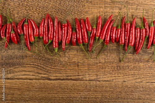Very Hot Chili Peppers on Rustic Wooden Background Top View