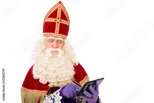 Saint Nicholas looking on tablet or smart phone