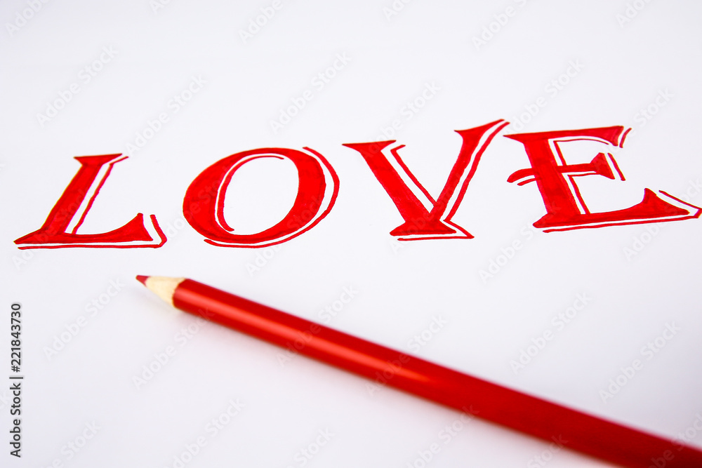Word Love written on white paper with red pencil Word Love written on white paper with red pencil