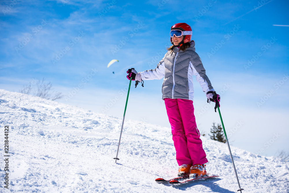Happy little girl on the ski slopes