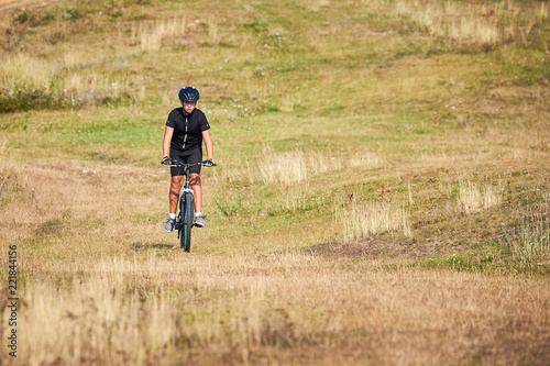 Young Cyclist Riding the Bike on the hill