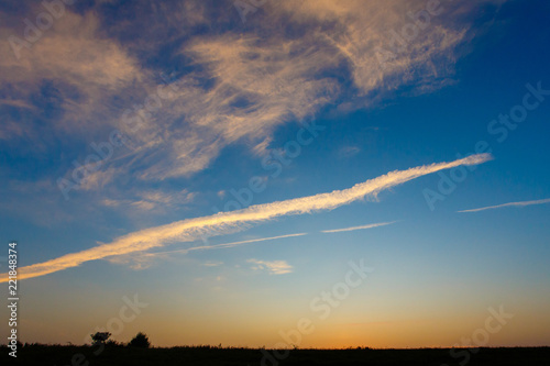 Horizon line lit with sun rays at daybreak. Morning landscape