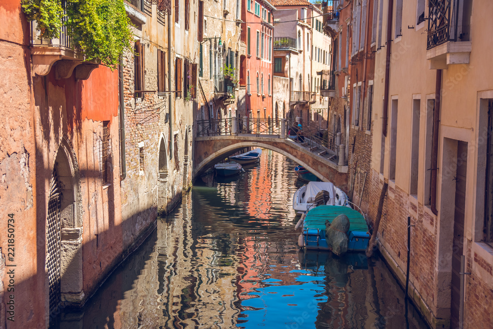 boats in narrow canals in Venice, Italy