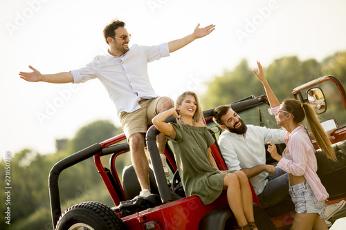 Happy friends having fun in convertible car at vacation © BGStock72