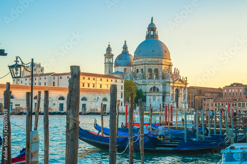 Beautiful view of traditional Gondolas on Canal Grande with historic Basilica di Santa Maria della Salute in Venice, Italy © k_samurkas