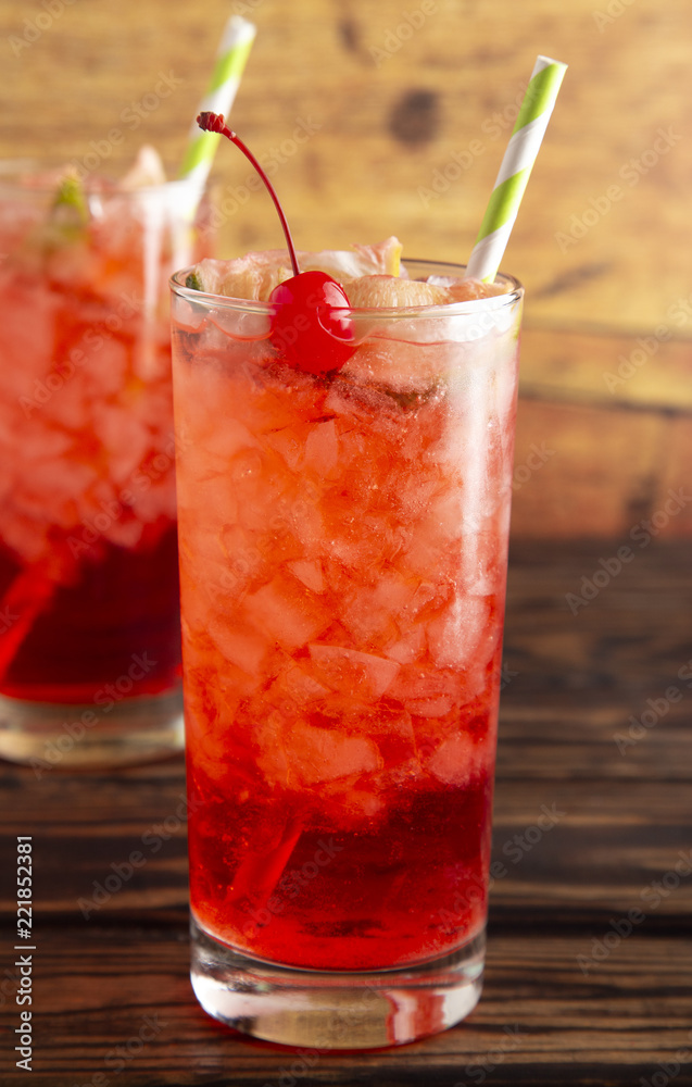 Glass of Cold Refreshing Cherry Limeade on a Wooden Table Glass of Cold Refreshing Cherry Limeade on a Wooden Table