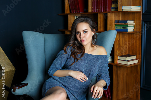 pregnant young woman sitting in a chair