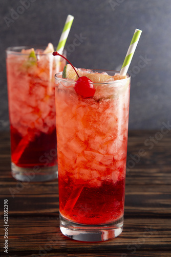 Glass of Cold Refreshing Cherry Limeade on a Wooden Table