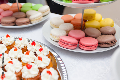 snacks, macaroons, tartlets with various fillings on white table