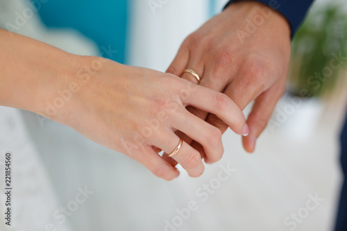 newlyweds holding each other by the hand close-up of hands