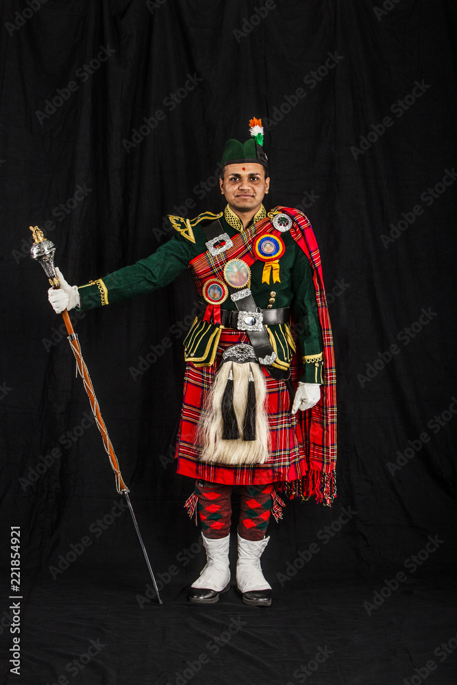 A portrait of an Indian American Scottish drum major looking at camera